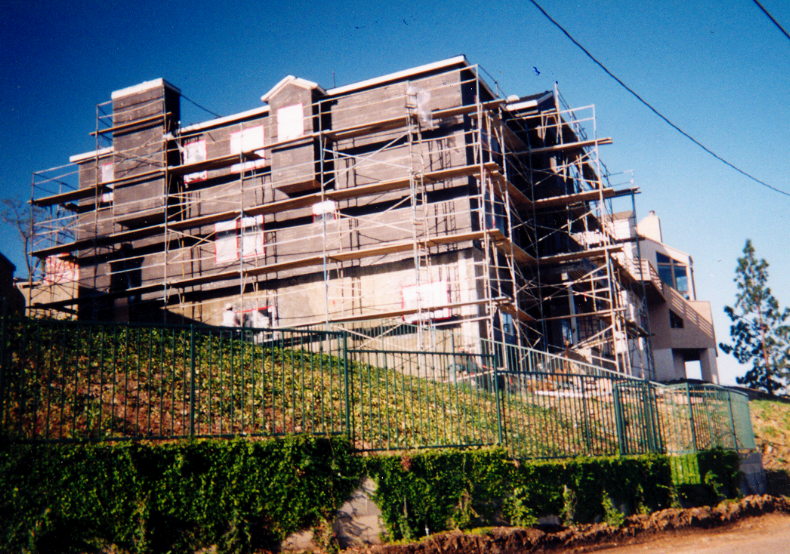 Multi-story residential structure under construction with scaffolding