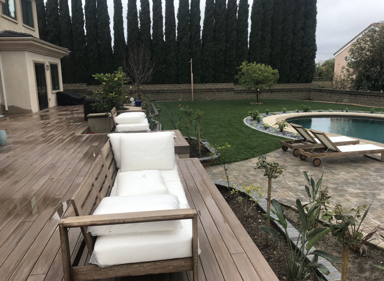 Outdoor living deck and pool area with lounge seating